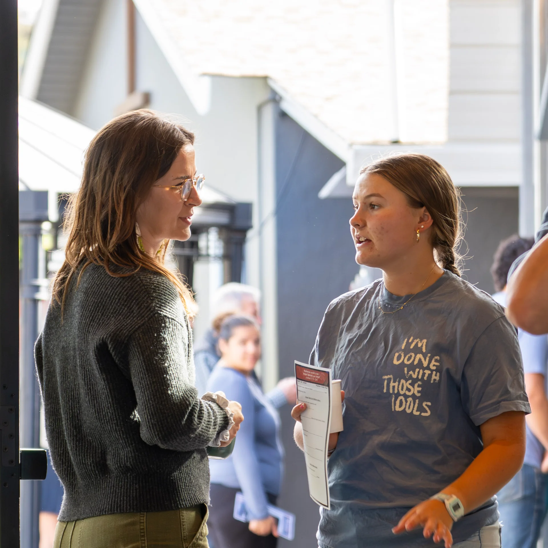 Two women in conversation outside the church