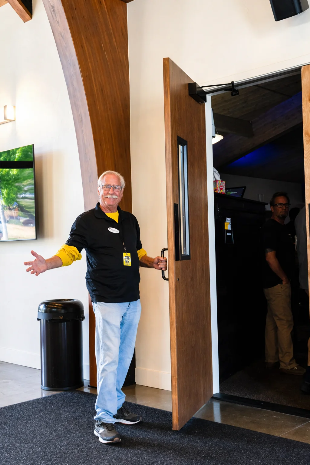 Greeter holding the door open at GateWay