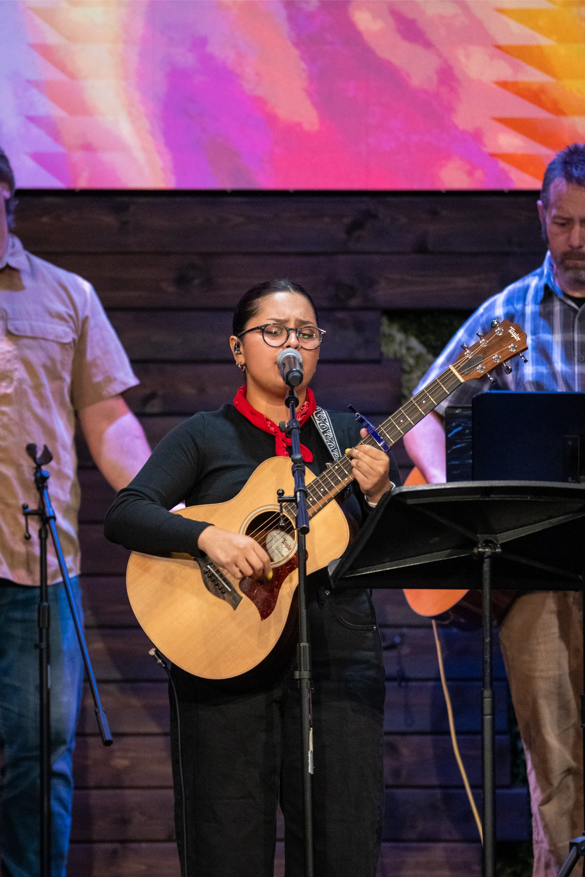 Vocalist with guitar leading worship at GateWay