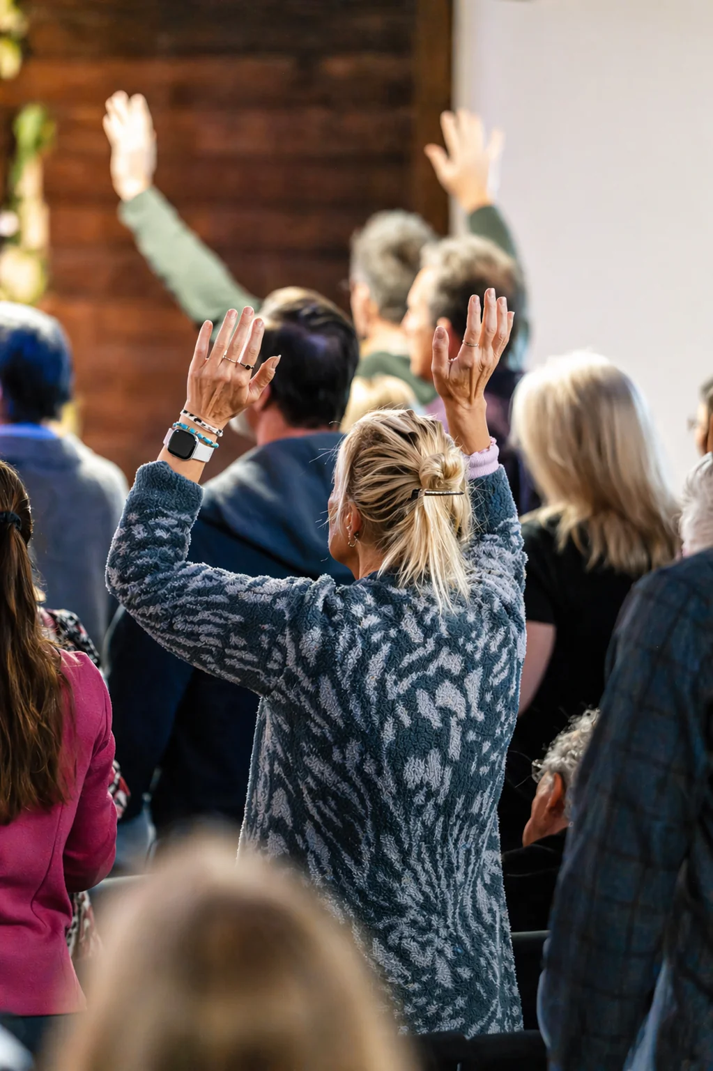 Congregation with hands raised in worship at GateWay